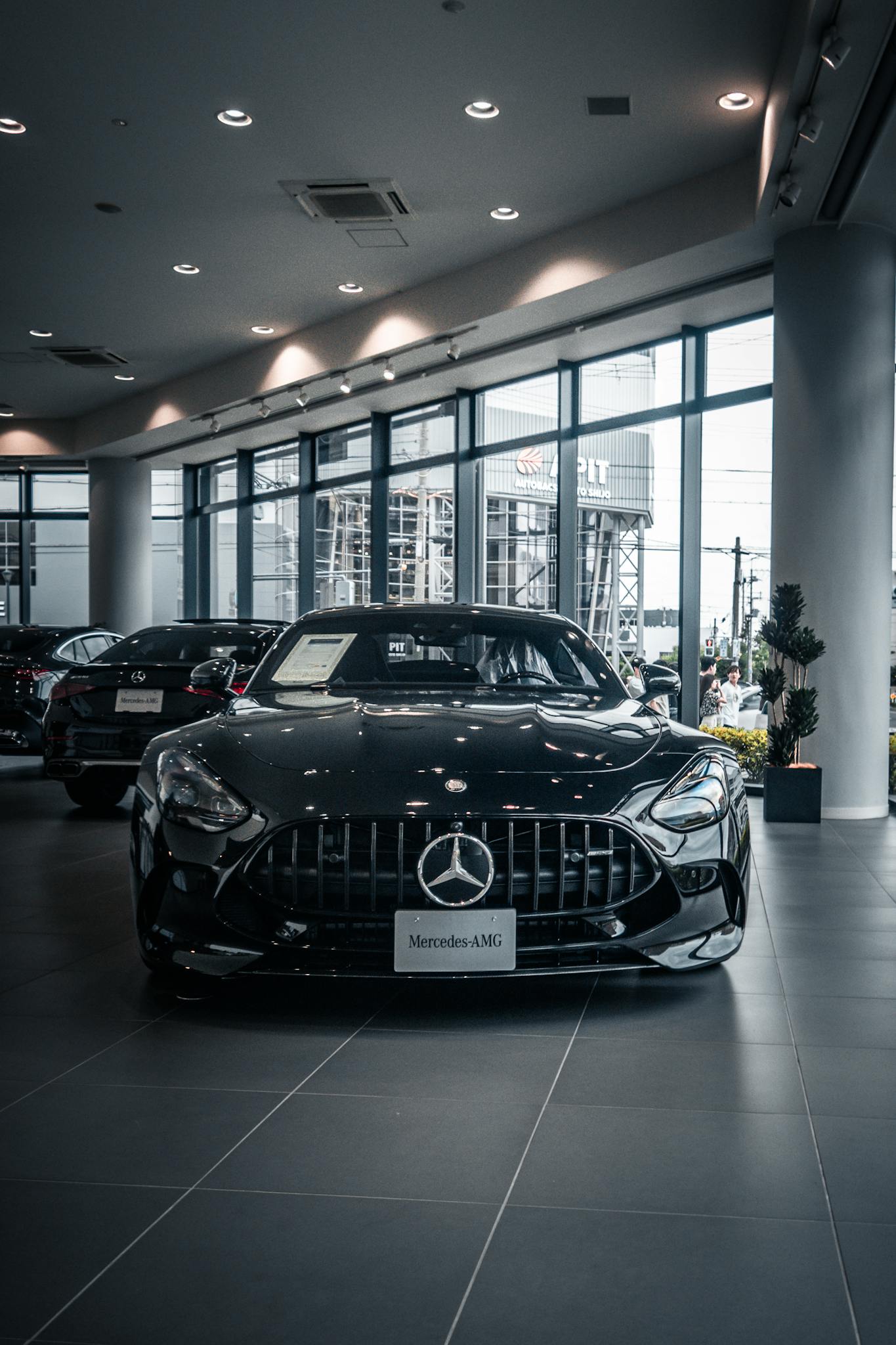 A mercedes car in a showroom with a black background